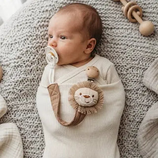 Univers Nest pacifier clip with soft fabric strap and clip, designed to securely hold a baby soother.
