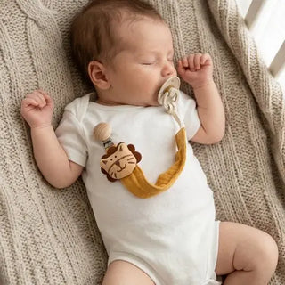 Universal Nest baby pacifier clip with soft fabric strap and clip, designed to keep baby soothers secure and within reach.