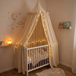 Baby bed canopy in soft white fabric with a delicate mesh top, designed by Univers Nest for a cozy, magical nursery space.