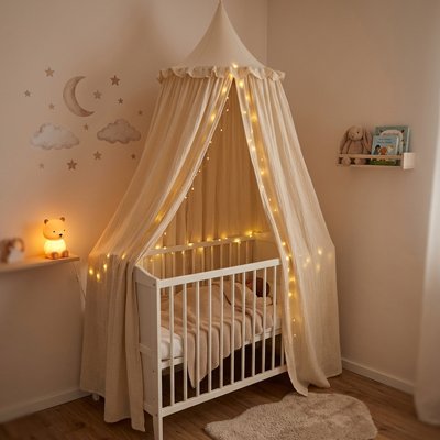 Baby bed canopy in soft white fabric with a delicate mesh top, designed by Univers Nest for a cozy, magical nursery space.