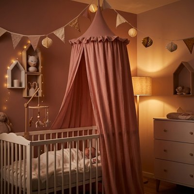 Baby bed canopy by Univers Nest, Magical Cocoon, featuring a soft, airy fabric draped over a crib for a cozy, enchanting nursery space.