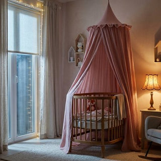 Baby bed canopy from Univers Nest Magical Cocoon, airy sky-blue fabric draped over a crib, creating a cozy, magical sleeping space.