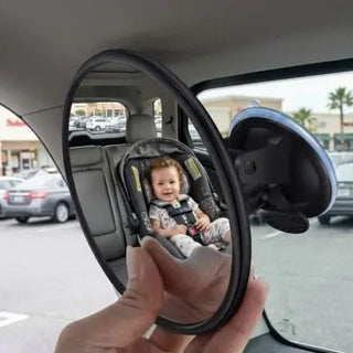 Universal Nest baby car mirror for clear visibility, showing a reflective view of a baby seat in a car interior.