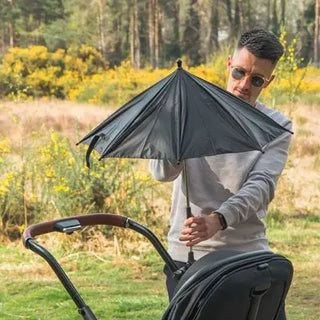 Adjustable baby stroller sunshade umbrella by Univers Nest providing sun protection for a stroller with a lightweight design.