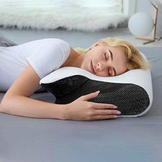 Ergonomic pillow by Univers Nest with contoured design for neck support and comfort during sleep.