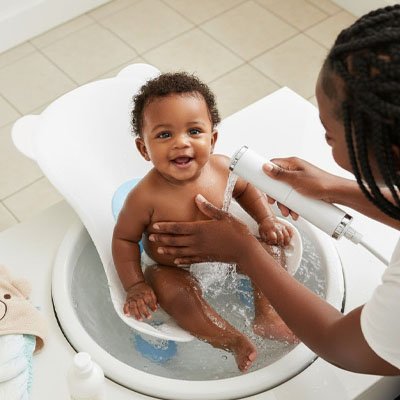 Ergonomic baby bath chair by Univers Nest with soft padding and support, designed for comfortable bath time for infants.