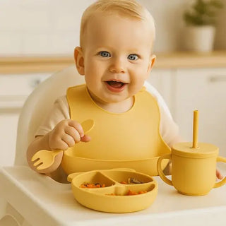 BPA-free baby tableware set by Univers Nest with colorful bowls, plates, and utensils on a wooden table for safe feeding.